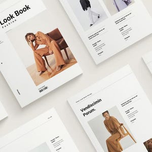 May include: A selection of white Look Book fashion magazines featuring models in different outfits. The magazines are arranged on a white surface, with the title "Look Book Fashion" displayed on the cover of one.