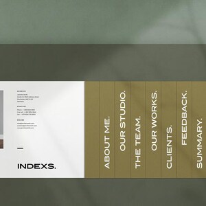 May include: A modern business card design with the word "INDEXS." in a bold font. The card features a photo of a white chair, contact information, and a sectioned panel with headings like "About Me" and "Our Studio."