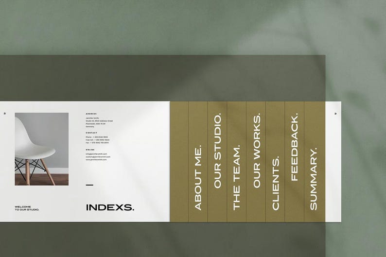 May include: A modern business card design with the word "INDEXS." in a bold font. The card features a photo of a white chair, contact information, and a sectioned panel with headings like "About Me" and "Our Studio."