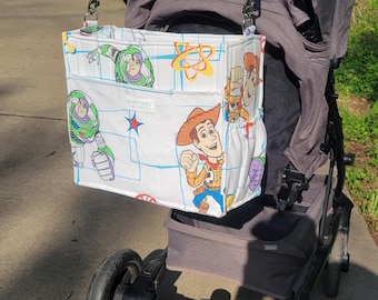 Large Park Bag featuring stroller straps, adjustable shoulder strap,  plenty of pockets! In Woody & Buzz print!