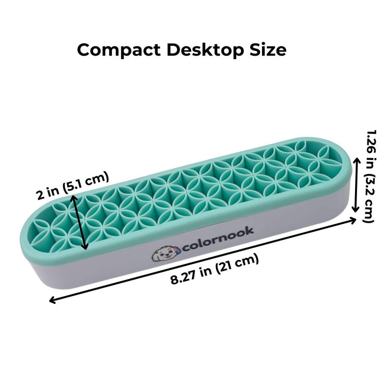 May include: A rectangular organizer with a light gray base and a mint green silicone insert featuring a repeating geometric flower pattern. The text "colornook" and a small dog logo are printed on the side. Dimensions are 8.27 inches by 2 inches by 1.26 inches.