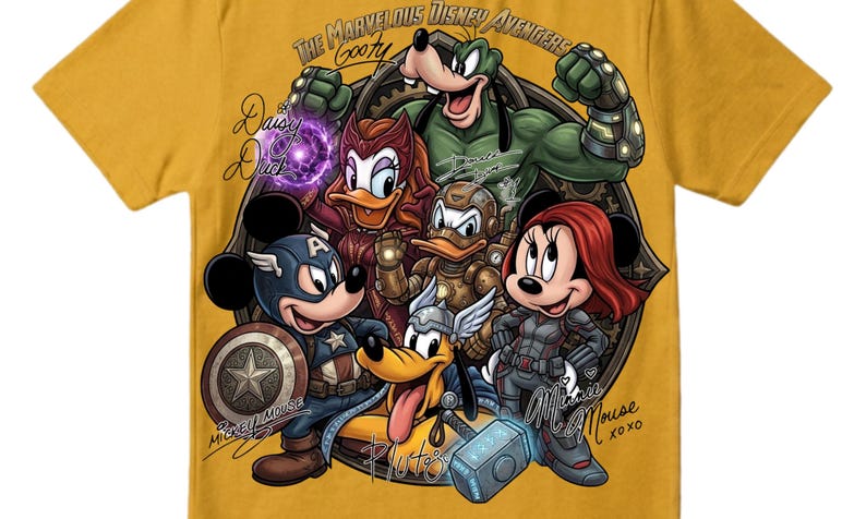 May include: Mustard yellow t-shirt featuring a graphic of Disney characters reimagined as Avengers. Mickey Mouse as Captain America, Minnie Mouse as Black Widow, and Goofy as Hulk are among the characters. Text includes "The Marvelous Disney Avengers" and character names.