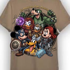 May include: Tan t-shirt featuring a graphic of Disney characters as Marvel Avengers. The design includes Mickey Mouse as Captain America, Minnie Mouse as Black Widow, and Goofy as the Hulk. Text includes "The Marvelous Disney Avengers Goofy" and "Daisy Duck".