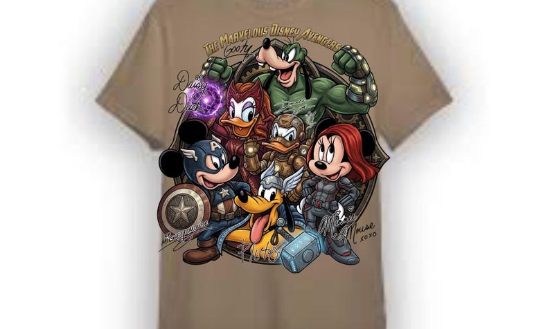 May include: Tan t-shirt featuring a graphic of Disney characters as Marvel Avengers. The design includes Mickey Mouse as Captain America, Minnie Mouse as Black Widow, and Goofy as the Hulk. Text includes "The Marvelous Disney Avengers Goofy" and "Daisy Duck".
