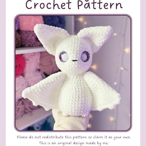 May include: A white plush bat crochet toy with large pointed ears and iridescent eyes. The text reads: Extra-Large Bat Crochet Pattern. Please do not redistribute this pattern or claim it as your own. This is an original design made by me. You may sell your physical pieces. Tag @loopsandknotscrochet as the original designer.