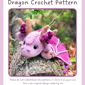 May include: A crochet dragon toy in shades of light and dark purple with tan horns and dark purple floral accents. The text reads: Wisteria the Giant Wood Dragon Crochet Pattern. Please do not redistribute this pattern or claim it as your own.
