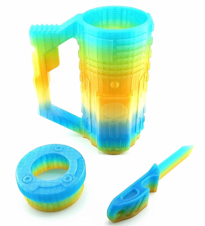 May include: A 3D-printed mug, a small circular object, and a knife-like object. All items are in a gradient of blue, yellow, and green. The mug has a handle and a cylindrical shape. The other objects have a similar color scheme.