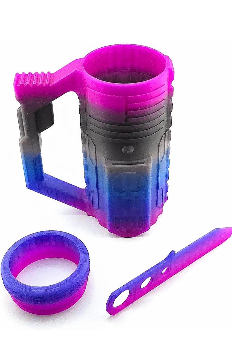 May include: A 3D-printed mug, ring, and knife set with a gradient color scheme of pink, black, and blue. The mug features a handle and a skull design. The ring and knife are also 3D-printed.