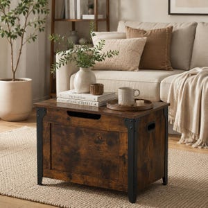 May include: A rectangular storage chest with a dark brown wood grain finish and black metal corner brackets. The chest features a front cutout handle, side handles, and a flat top surface holding two stacked books, a vase, and a wooden tray.