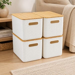 May include: Four white storage bins with woven texture and bamboo lids. Each bin has a rectangular handle cutout. The bins are stacked, creating a neat and organized look. Ideal for home organization and storage.
