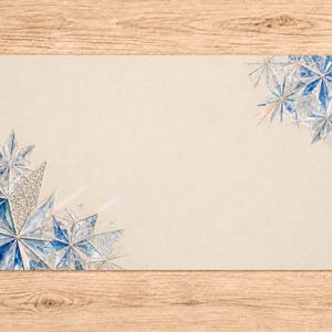 May include: A rectangular beige card featuring decorative blue and white geometric star-shaped patterns in the bottom-left and top-right corners. The stars are composed of multifaceted blue and white segments with thin, metallic-colored lines.