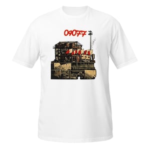 May include: White t-shirt featuring a graphic illustration of a building with red and white flags. The number "09077" is printed in red above the building. The shirt is made of a soft, comfortable material.