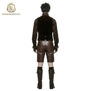 May include: A dark brown velvet vest with a back buckle, a long-sleeved brown shirt with ruffled cuffs, brown leather shorts, and dark brown knee-high boots. The image includes the text PREMIUM LEATHER with a gold crown logo in the top corner.