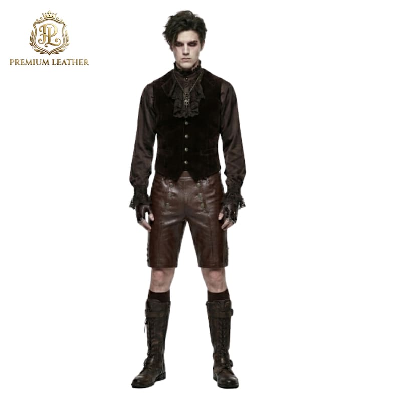 May include: A dark brown velvet vest with a ruffled collar, a long-sleeved brown shirt with lace cuffs, brown leather shorts, and tall brown lace-up boots. The outfit includes fingerless gloves and a dark pendant necklace on a chain.
