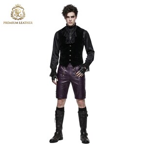 May include: A black long-sleeved shirt with a ruffled collar, a black velvet vest with silver buttons, and purple leather shorts featuring double rows of brass-toned buttons. The outfit includes black fingerless gloves and tall black lace-up boots.