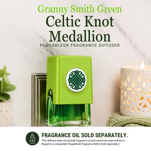 May include: A Granny Smith Green Plugables fragrance diffuser featuring a white circular medallion with a dark green Celtic knot design. The device is plugged into a wall outlet and includes text stating Granny Smith Green Celtic Knot Medallion.