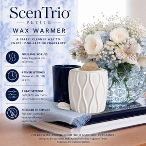 May include: A white ceramic wax warmer with a vertical wave pattern, featuring text that reads ScenTrio Petite Wax Warmer, No Flame No Fuss, 4 Timer Settings, 3 Heat Settings, and No Bulbs To Replace, alongside a dark blue cup and flowers.