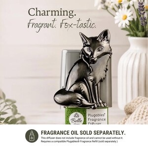 May include: A metallic silver-toned fox-shaped plug-in fragrance diffuser with the text Charming. Fragrant. Fox-tastic. and Plugables Fragrance Diffuser. The base includes text stating FRAGRANCE OIL SOLD SEPARATELY and additional usage information.