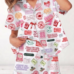 May include: White pajama set with a repeating pattern of books, hearts, and phrases like "Read More Books" and "Hot Girls Read Fantasy." The set includes a button-down shirt and shorts, both trimmed with white piping.