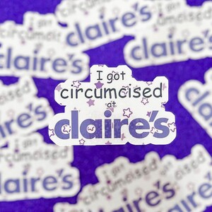 May include: A selection of white stickers with purple text on a purple backdrop. The stickers read "I got circumcised at Claire's" with star motifs. The word "Claire's" is in a decorative font.