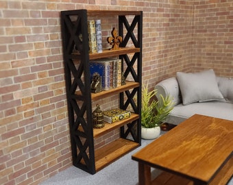 May include: A black metal bookshelf with five shelves, filled with books and decorative items. The bookshelf is against a brick wall and has a geometric design on the front.