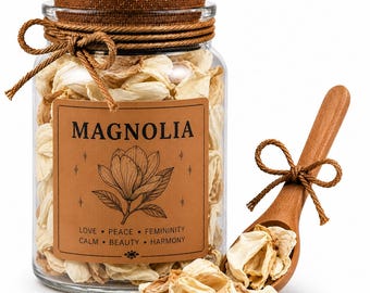 May include: A clear glass jar filled with dried magnolia petals, a wooden spoon, and a cork lid. The jar has a brown label with the word "MAGNOLIA" and a magnolia flower illustration. The label also includes the words "LOVE, PEACE, FEMININITY, CALM, BEAUTY, HARMONY".