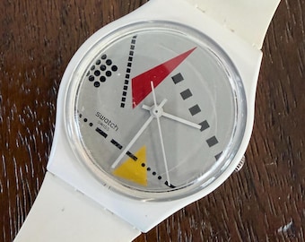 Swatch 1984 Reloaded Armbanduhr: Weiße Biokeramik, Multicolor Memphis Ziffernblatt, 34 mm SO31W106, neue Batterie