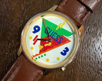 Vintage 1990 Guess Jeans Watch Gold Tone Case White Triangle Logo Dial Memphis Style Brown Leather Strap 36mm Working Wearable