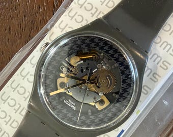 Swatch Greybolino SUOM109 New Herren 41 mm | Skelett-Zifferblatt, Buntes Uhrwerk, Einfarbig Grau | Original Box und Papiere inklusive