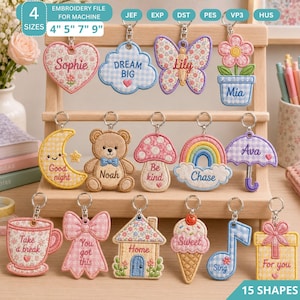 May include: A collection of 15 embroidered keyring designs featuring shapes like a heart, cloud, butterfly, flower, moon, bear, mushroom, rainbow, umbrella, teacup, bow, house, ice cream, music note, and gift, each with text and patterns.