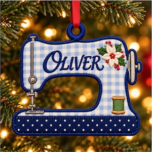 May include: A sewing machine-shaped Christmas ornament featuring a light blue and white gingham pattern, the name Oliver embroidered in dark blue, a white poinsettia with red berries, and a green thread spool, hanging from a red ribbon.
