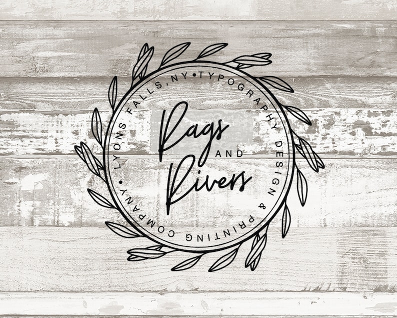 May include: Black and white logo design with a wreath of leaves around the text "Rags and Rivers Printing & Typography Design" with the location "Lyons Falls, NY" underneath.