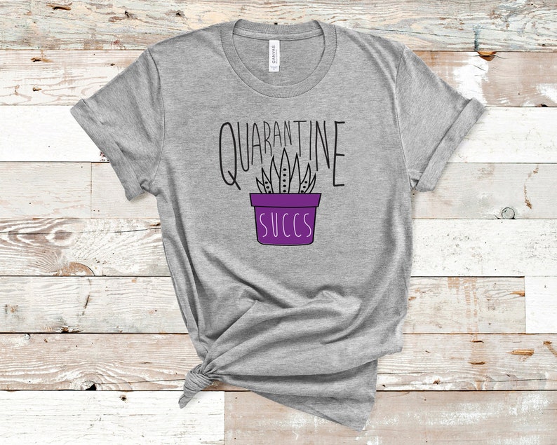 May include: Grey t-shirt with a purple succulent plant illustration and the text "Quarantine Succs".