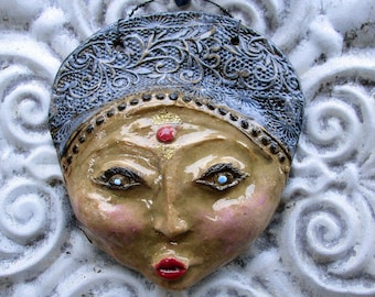 ceramic face wall art.