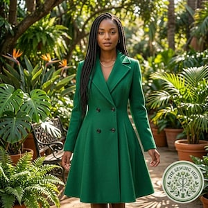 May include: A double-breasted emerald green coat with a notched lapel, long sleeves, and a flared skirt silhouette. The coat features four dark buttons arranged in two vertical rows on the front, creating a structured and tailored appearance.