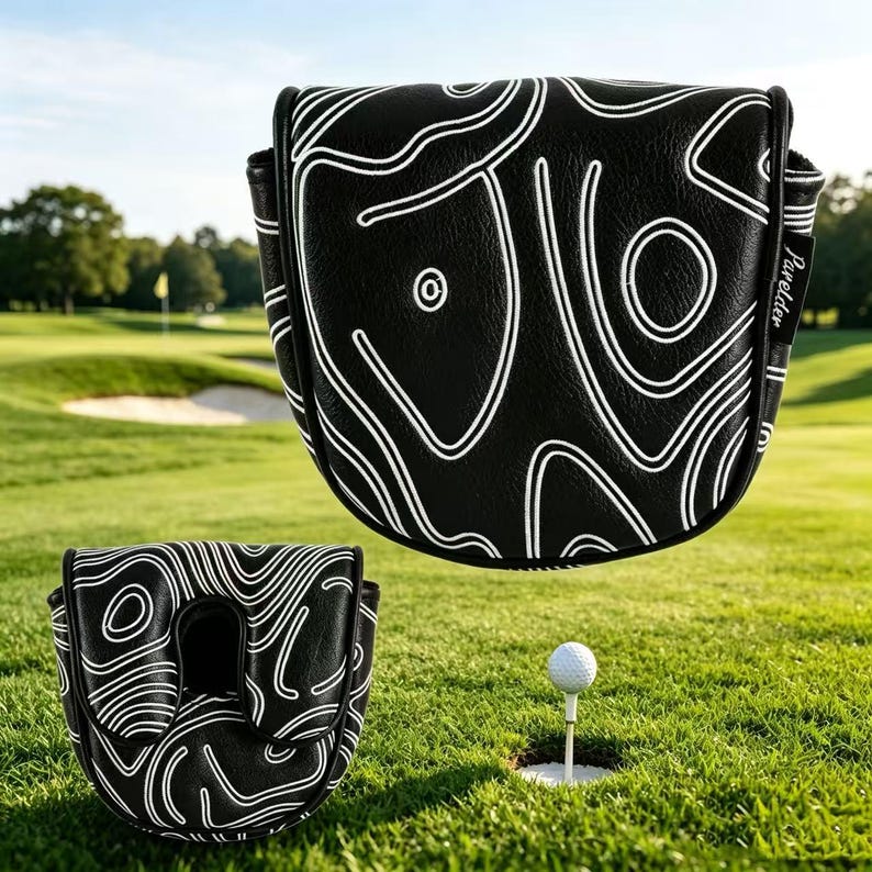 May include: A black golf putter headcover featuring a white topographic map line pattern. The cover has a rounded shape with a small black tag on the side displaying the white text Parelder. A second view shows the underside opening.