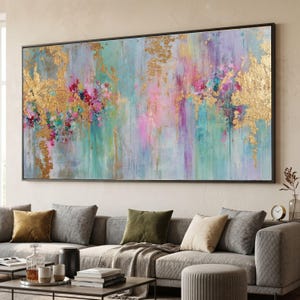 May include: A large rectangular abstract painting in a black frame featuring a blend of teal, pink, and purple vertical brushstrokes accented with textured gold leaf patches. The artwork displays a vibrant colour palette with layered paint applications.