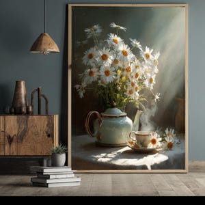 May include: A framed art print depicting a still life with a bouquet of white daisies. A light blue teapot and teacup are on a table, with steam rising from the cup. The artwork has a vintage aesthetic, with a soft, diffused light.