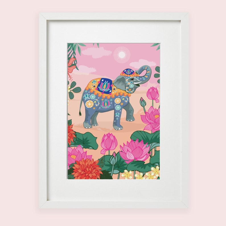 May include: A framed illustration of a blue and white decorated elephant standing in a field of pink and white lotus flowers. The elephant is adorned with colorful floral patterns and has a pink and yellow saddle. The background is a soft pink with a white sun.