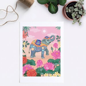 May include: A gray elephant decorated with colorful patterns stands in a field of pink lotus flowers. The elephant has a pink and yellow saddle and is surrounded by green leaves and flowers.