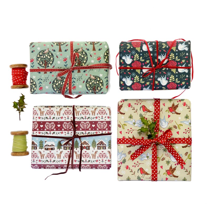 May include: Four wrapped Christmas gift boxes with different designs. The boxes are tied with red ribbon and have a variety of patterns, including birds, trees, and houses.