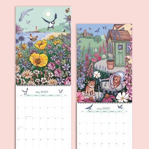 May include: Two wall calendars for May and June 2027. The May page features a coastal scene with a puffin, lighthouse, and yellow poppies. The June page shows a garden with a shed, flowers, and a kitten inside a metal watering can.
