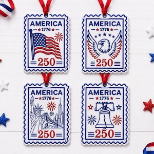 May include: Four rectangular ornaments shaped like postage stamps with scalloped edges and red ribbon loops. Each features the text AMERICA 1776 and 250 in blue and red. Designs include an American flag, a bald eagle, the Statue of Liberty, and a bell.