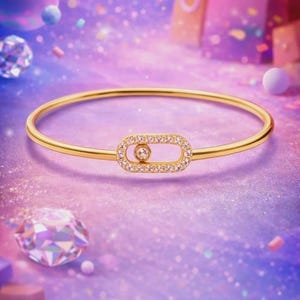May include: A gold bangle bracelet featuring a rectangular, diamond-set centrepiece. The bracelet is displayed against a shimmering, purple and pink backdrop with floating orbs and geometric shapes. A single, larger diamond is visible.