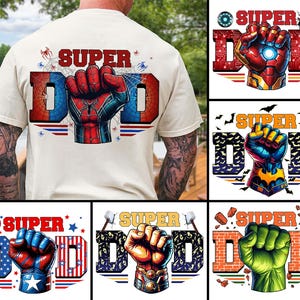 May include: A beige t-shirt with a "SUPER DAD" graphic featuring a Spider-Man fist design. Additional designs include Iron Man, Batman, Captain America, Thor, and Hulk fists. The shirt is a casual wear item.