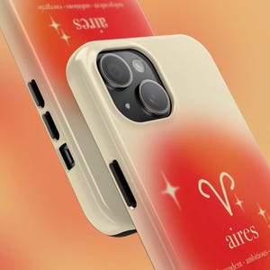 May include: Cream and red gradient phone case with the Aries zodiac symbol and the word "aires". The case has a glossy finish and a camera cutout. The background is a warm orange.
