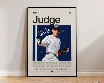 May include: A framed vertical poster featuring a baseball player in a pinstriped uniform and helmet, with the text "Judge" at the top, a signature, and detailed statistical information at the bottom, set against a cream and navy blue background.