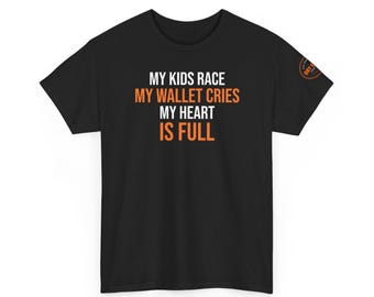 May include: Black t-shirt with the text "MY KIDS RACE, MY WALLET CRIES, MY HEART IS FULL" in white and orange. A small orange and white logo is on the right sleeve. The shirt is made of a soft material.