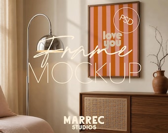 May include: A framed poster with vertical orange and pink stripes and the words "love you" in white. The poster is hanging on a wall above a wooden cabinet. A silver floor lamp and a decorative vase are also in the room.