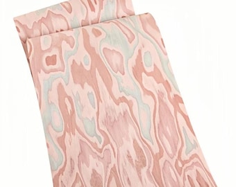 May include: Two sheets of wood veneer with a distinctive, swirling grain pattern. The wood displays a mix of pink, light blue, and brown hues, producing a natural, organic look. The sheets are slightly curved, indicating they are flexible.